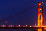 Eclipsed moon through the Golden Gate Bridge cables